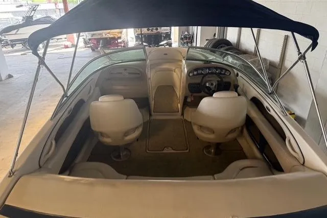 Slide: The Image of Interior view of a 2002 Chaparral 216 SSi boat with canopy and seating. - 21