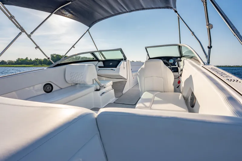 Slide: The Image of 2026 Four Winns H1 OB boat interior with white seating and canopy on a sunny day. - 22