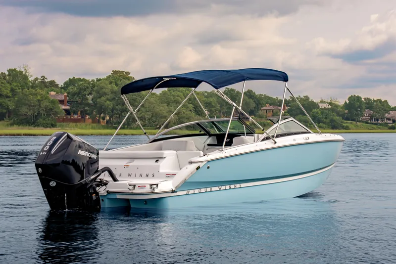 Slide: The Image of 2026 Four Winns H1 OB boat with Mercury engine on a serene lake. - 8
