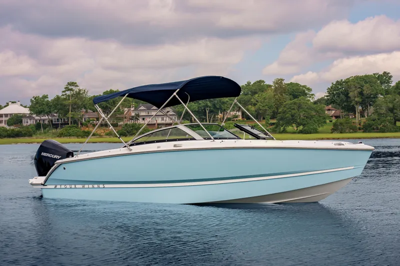 Slide: The Image of 2026 Four Winns H1 OB boat on calm water with scenic background. - 7