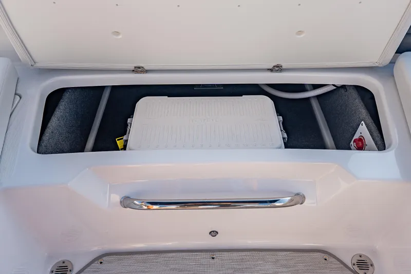 Slide: The Image of Storage compartment of 2026 Four Winns H1 OB boat with cooler and safety equipment. - 27