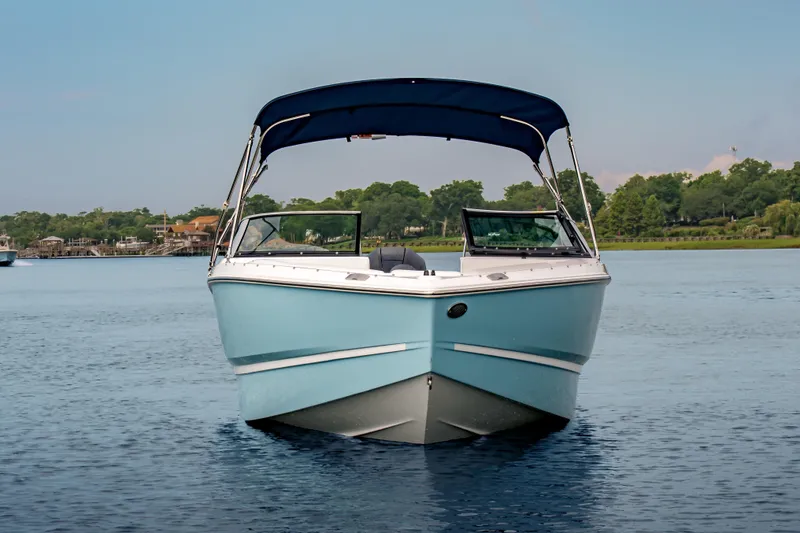 Slide: The Image of The image shows a 2026 Four Winns H1 OB boat on calm water with a blue canopy. - 5