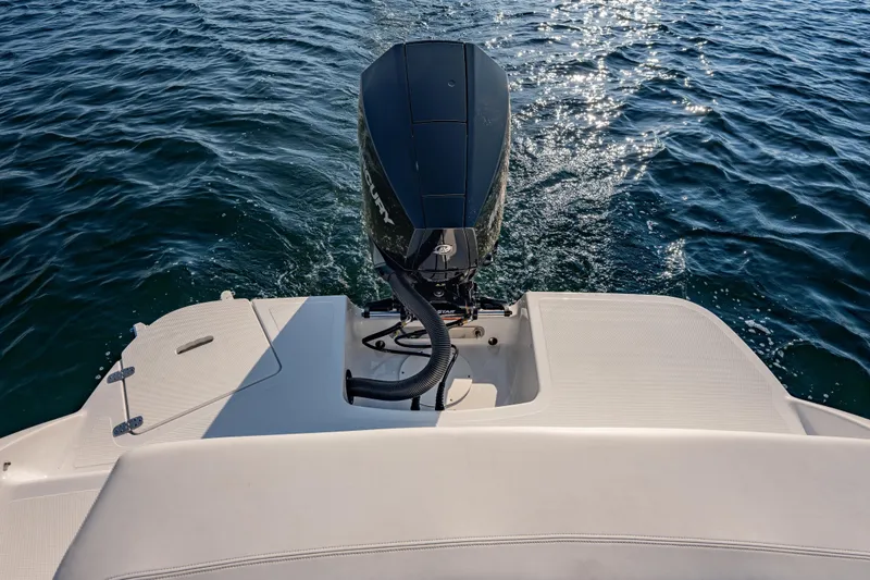 Slide: The Image of The image shows the stern of a Four Winns H1 OB boat on the water. - 12