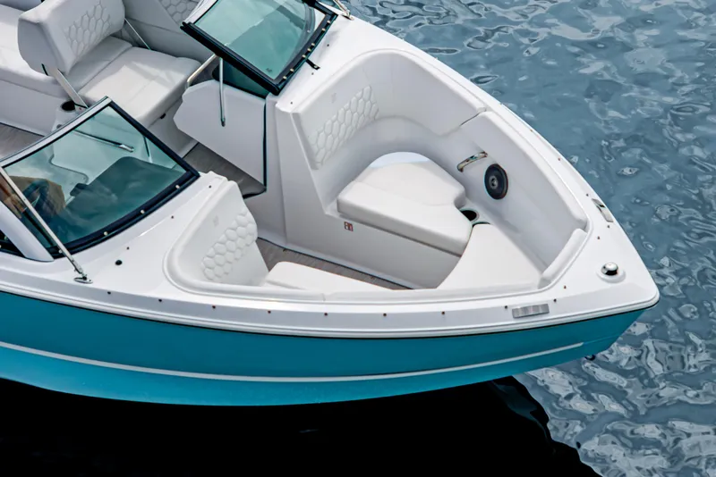 Slide: The Image of 2026 Four Winns H1 OB boat with white seating and blue hull on water. - 11