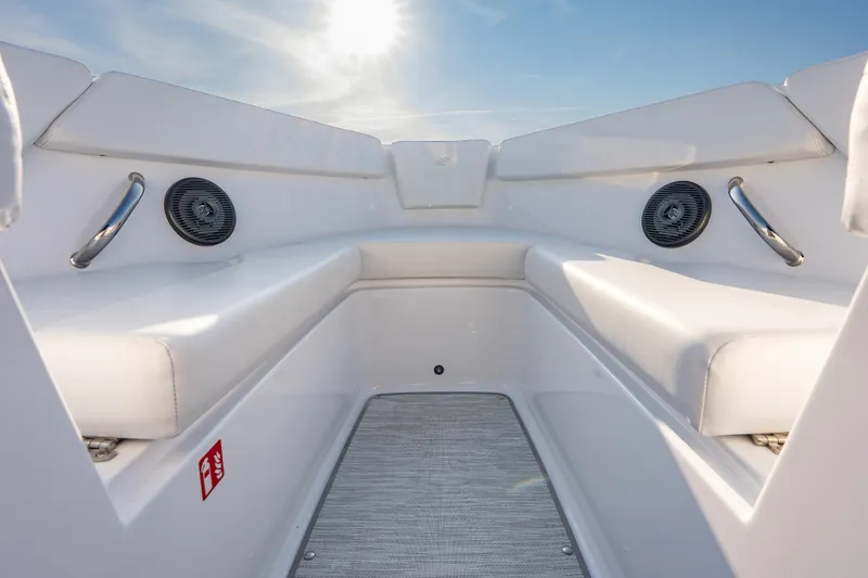 Slide: The Image of 2026 Four Winns H1 OB boat interior with white seating and speakers under sunny sky. - 21