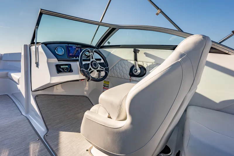 Slide: The Image of Interior of 2026 Four Winns H1 OB boat, featuring modern steering and dashboard controls. - 16
