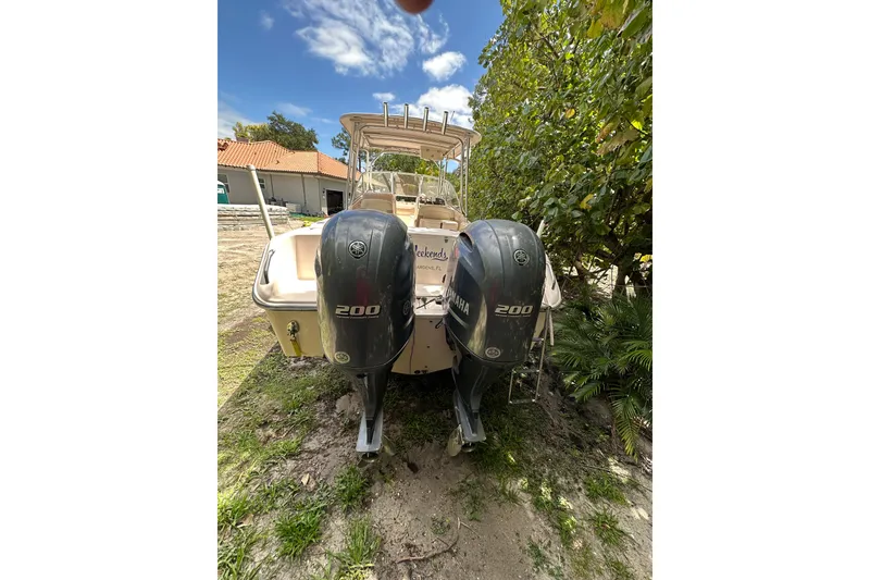 Slide: The Image of 2014 Grady-White Freedom 275 boat with dual Yamaha 200 engines, parked outdoors. - 11