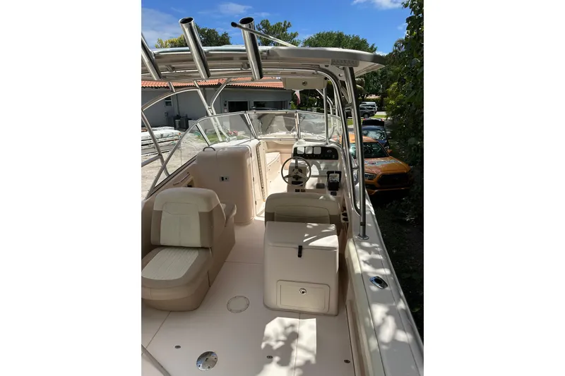 Slide: The Image of 2014 Grady-White Freedom 275 boat interior with seating and steering console. - 12