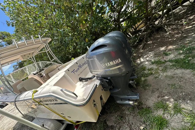 Slide: The Image of 2014 Grady-White Freedom 275 boat with Yamaha outboard motors, parked on grass. - 14