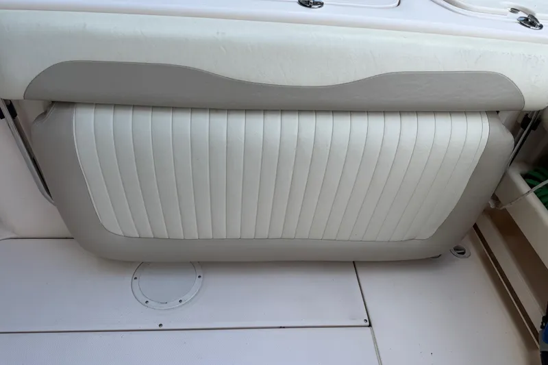 Slide: The Image of 2014 Grady-White Freedom 275 boat seat with white and beige upholstery. - 17