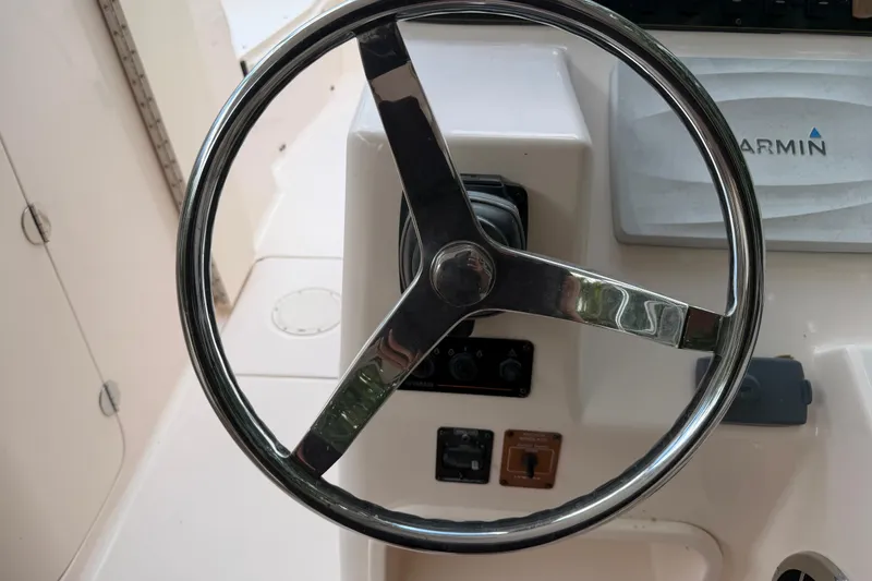 Slide: The Image of Steering wheel of 2014 Grady-White Freedom 275 boat with Garmin navigation system. - 19