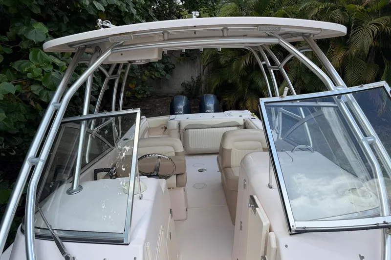 Slide: The Image of 2014 Grady-White Freedom 275 boat interior with seating and steering wheel. - 25
