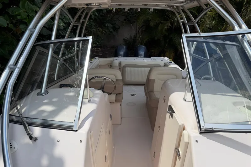 Slide: The Image of 2014 Grady-White Freedom 275 boat interior with seating and steering wheel. - 29