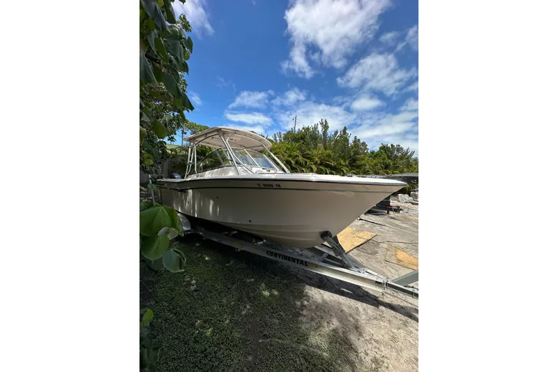 Slide: The Image of 2014 Grady-White Freedom 275 boat on trailer under blue sky. - 4