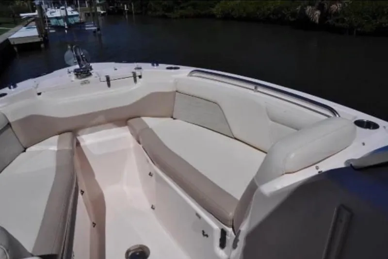 Slide: The Image of 2014 Grady-White Freedom 275 boat interior with cushioned seating and water view. - 5