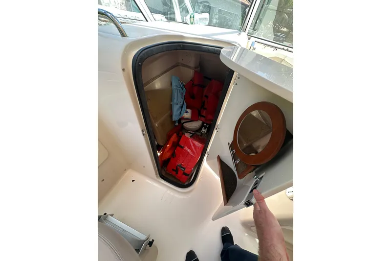 Slide: The Image of 2014 Grady-White Freedom 275 boat storage with life jackets and safety gear. - 6