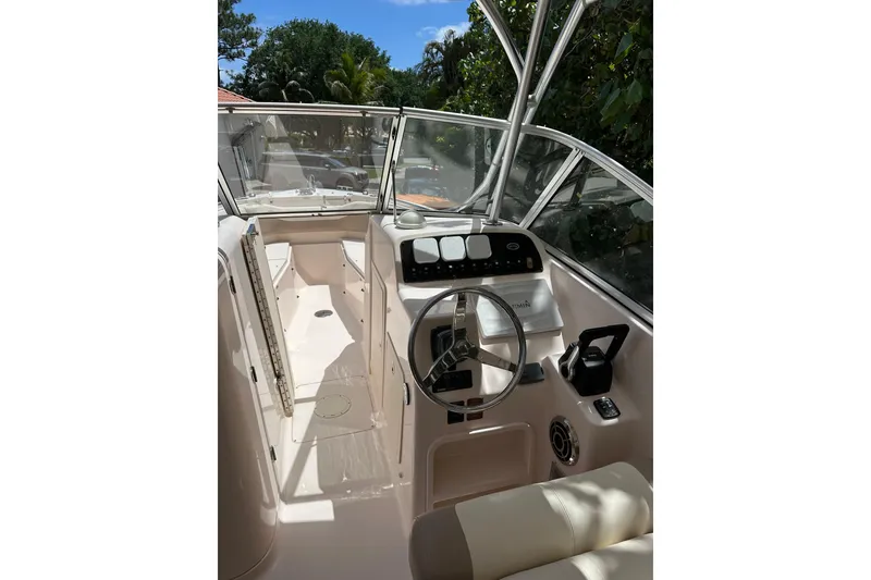 Slide: The Image of 2014 Grady-White Freedom 275 boat cockpit with steering wheel and controls. - 9