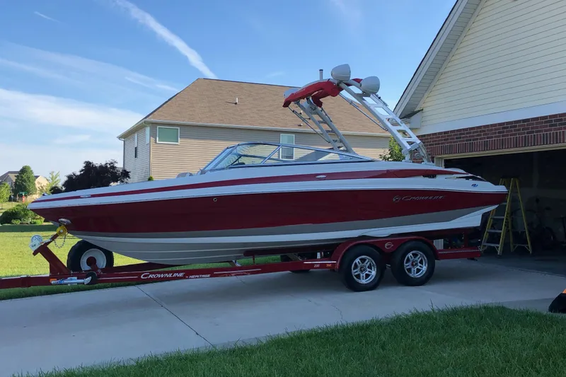 The Image of 2020 Crownline 235 SS boat on trailer in residential driveway. - 1