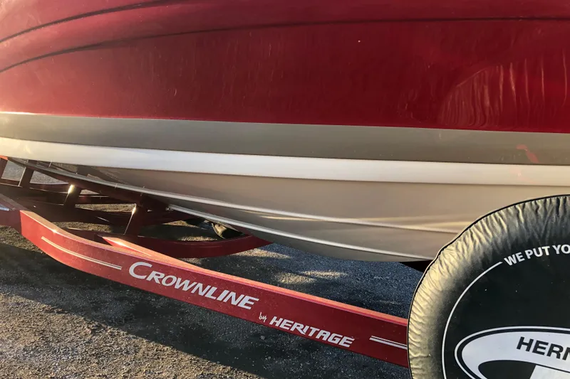 Slide: The Image of Red 2020 Crownline 235 SS boat on Heritage trailer, close-up view. - 18