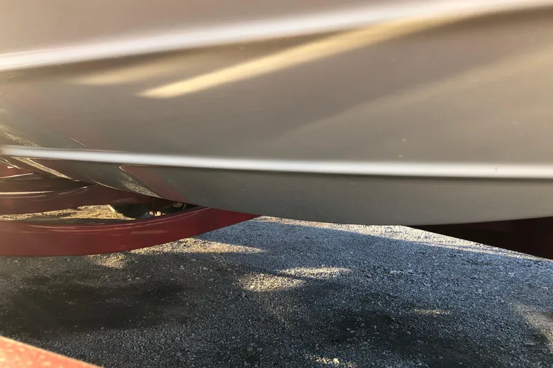 Slide: The Image of 2020 Crownline 235 SS boat hull on a trailer, side view. - 19