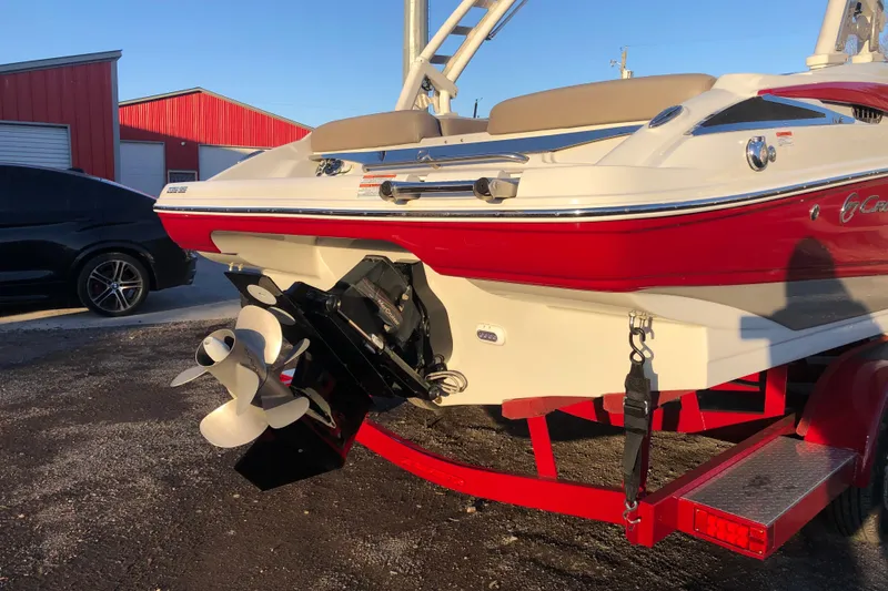 Slide: The Image of 2020 Crownline 235 SS boat on trailer, red and white design, rear view. - 21