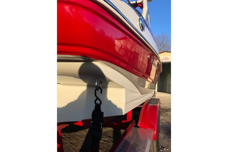 Slide: The Image of 2020 Crownline 235 SS boat on red trailer, close-up side view. - 23