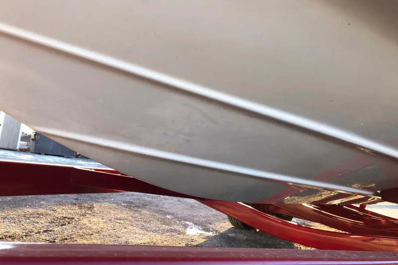 Slide: The Image of Close-up of 2020 Crownline 235 SS boat hull on red trailer. - 25