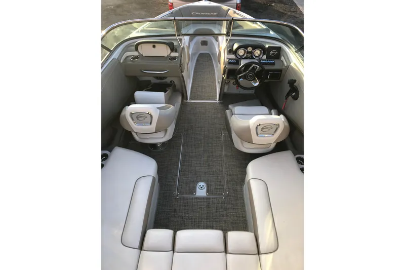 Slide: The Image of Interior view of 2020 Crownline 235 SS boat, featuring seating and dashboard controls. - 29