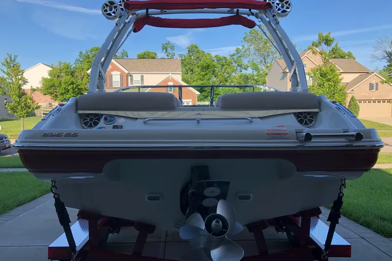 Slide: The Image of 2020 Crownline 235 SS boat on trailer, residential neighborhood background. - 3