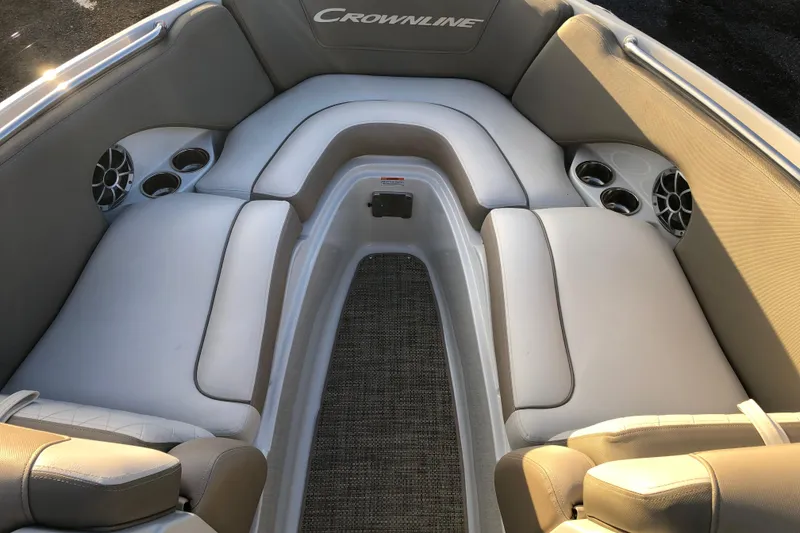 Slide: The Image of Interior of 2020 Crownline 235 SS boat with cushioned seating and cup holders. - 33