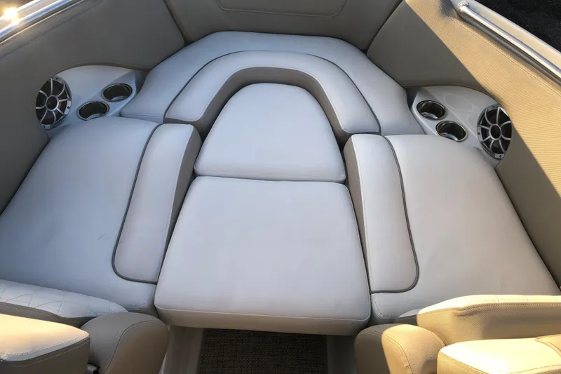 Slide: The Image of 2020 Crownline 235 SS boat interior with cushioned seating and cup holders. - 37