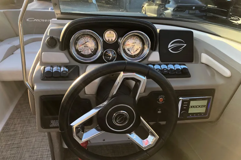 Slide: The Image of 2020 Crownline 235 SS boat dashboard with steering wheel and gauges. - 41