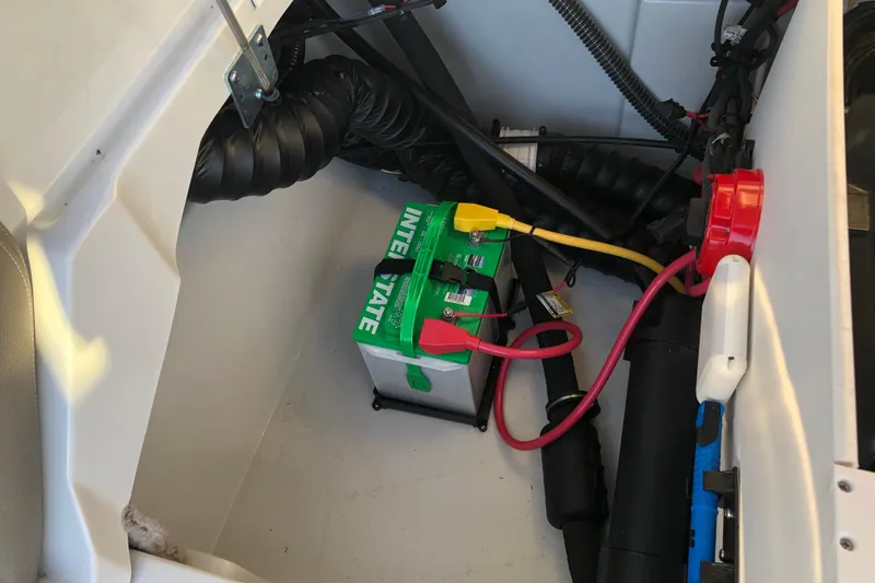 Slide: The Image of Battery compartment of a 2020 Crownline 235 SS boat with wiring and components. - 44