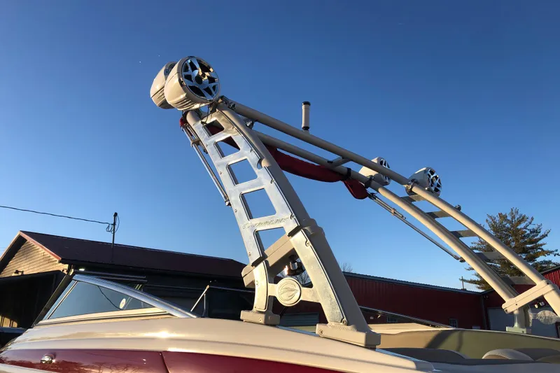 Slide: The Image of 2020 Crownline 235 SS boat with wakeboard tower and speakers against clear sky. - 50