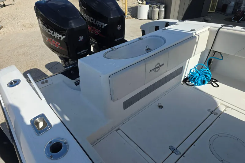 Slide: The Image of 2006 Fountain 23 Center Console boat with dual Mercury engines and deck storage. - 13