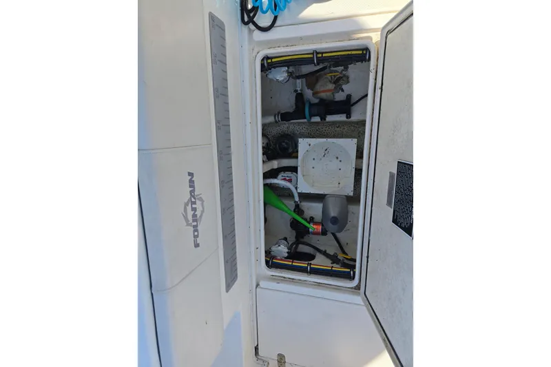 Slide: The Image of Open hatch of a 2006 Fountain 23 Center Console boat showing internal components. - 15