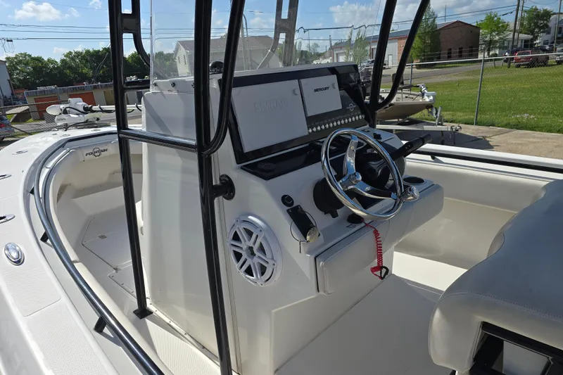Slide: The Image of 2006 Fountain 23 Center Console boat interior with steering wheel and control panel. - 16