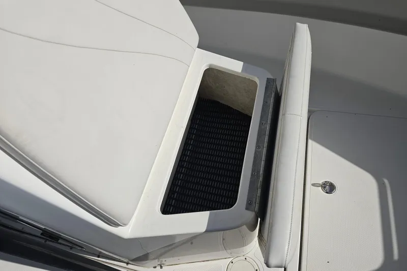 Slide: The Image of 2006 Fountain 23 Center Console boat interior storage compartment with cushioned seating. - 18