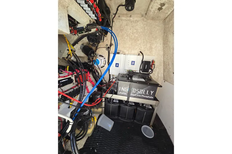 Slide: The Image of Electrical setup inside a 2006 Fountain 23 Center Console boat, featuring lithium iron phosphate batteries. - 21