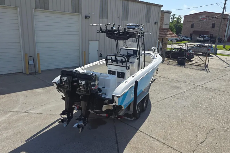 Slide: The Image of 2006 Fountain 23 Center Console boat with dual Mercury engines in a parking lot. - 3