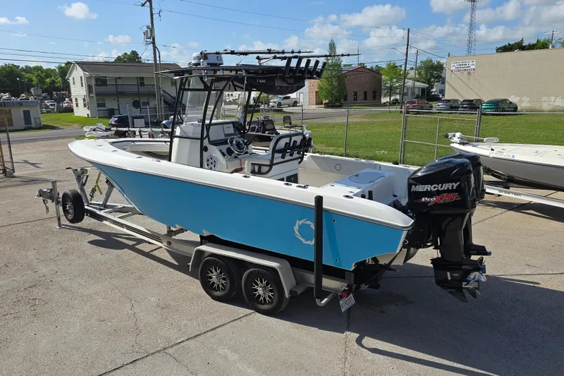 Slide: The Image of 2006 Fountain 23 Center Console boat on trailer with Mercury engine, parked outdoors. - 5