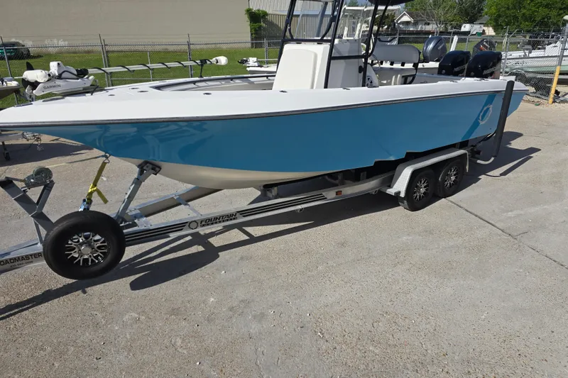 Slide: The Image of 2006 Fountain 23 Center Console boat on trailer, blue hull, parked outdoors. - 7