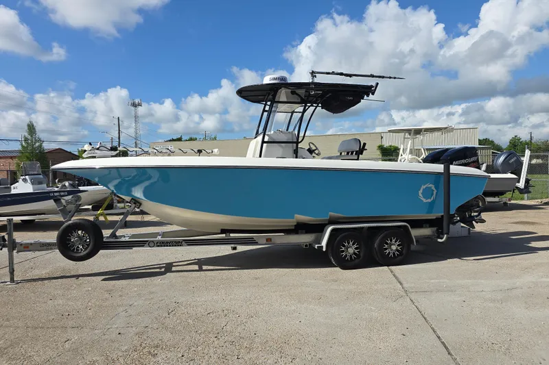 Slide: The Image of 2006 Fountain 23 Center Console boat on trailer under blue sky. - 8