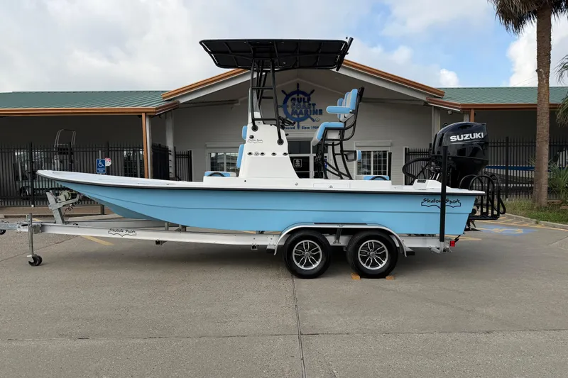 The Image of 2026 Shallow Sport 22 Sport boat on trailer, parked outside a building. - 0