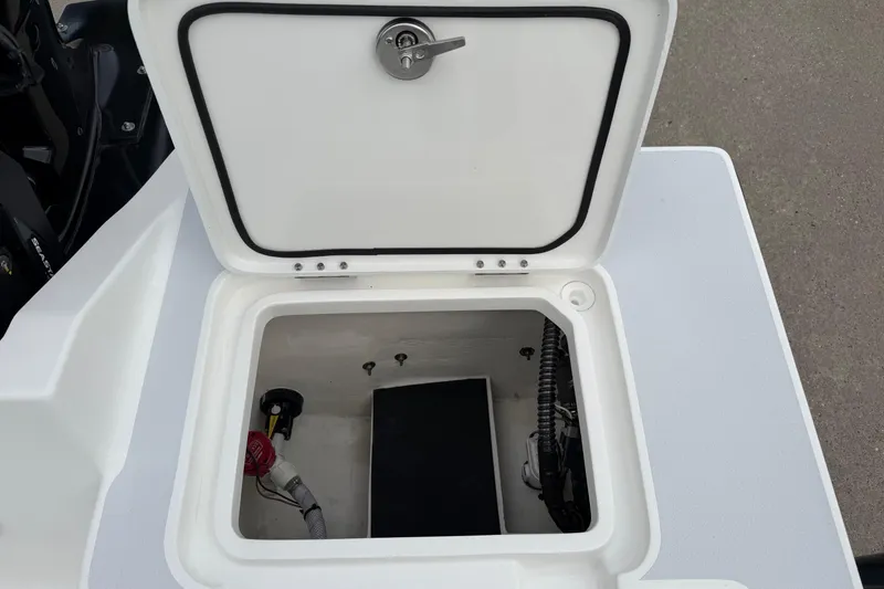 Slide: The Image of Open storage compartment on 2026 Shallow Sport 22 Sport boat, showcasing interior details. - 12