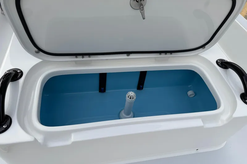 Slide: The Image of Open storage compartment in 2026 Shallow Sport 22 Sport boat, featuring blue interior. - 16