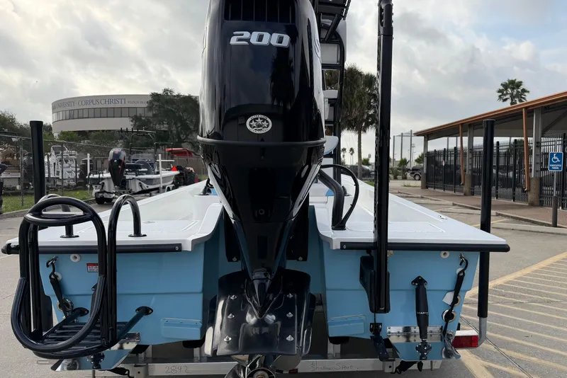 Slide: The Image of 2026 Shallow Sport 22 Sport boat with powerful 200 HP engine, parked outdoors. - 5