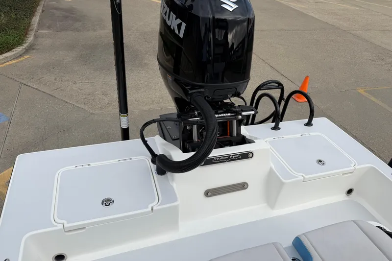 Slide: The Image of 2026 Shallow Sport 22 Sport boat with Suzuki outboard motor, docked on concrete surface. - 6