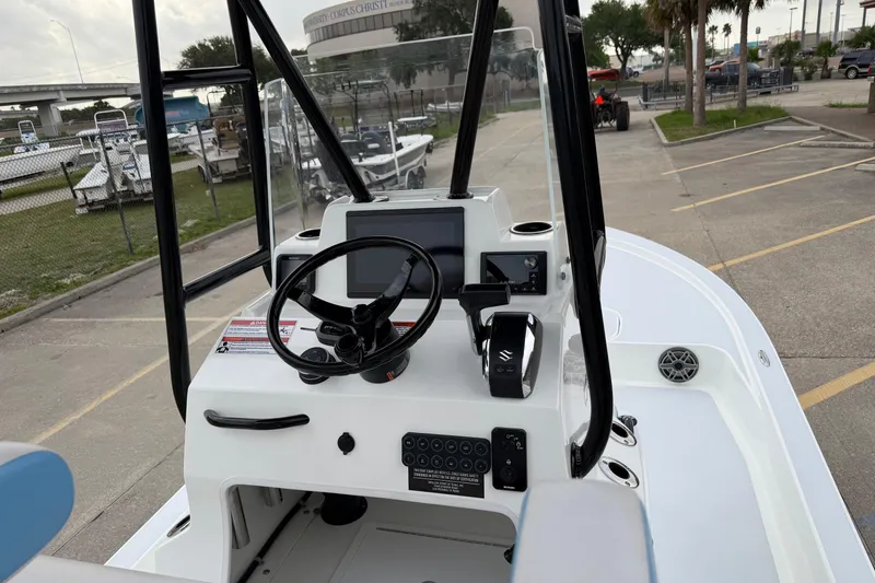 Slide: The Image of 2026 Shallow Sport 22 Sport boat dashboard with steering wheel and controls. - 7