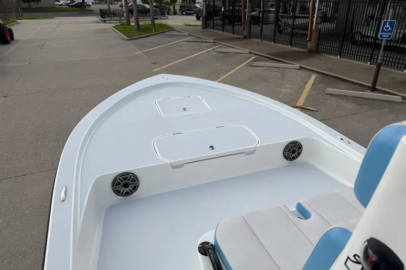 Slide: The Image of 2026 Shallow Sport 22 Sport boat, featuring spacious deck and seating, parked in a lot. - 8